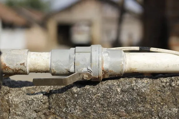 Stuck and Calcified Ball Valve An old, calcified PVC ball valve being cut out of a pipeline