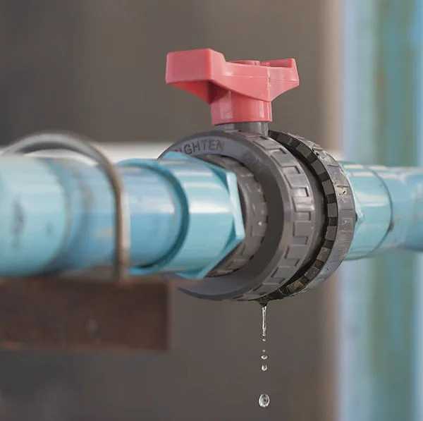 Leaking PVC Valve Stem A PVC ball valve with a small drip coming from the handle stem