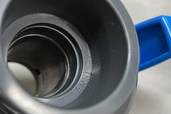 Identifying Ball Valve Size A close-up of the size marking (e.g., 1 inch) embossed on the body of a PVC ball valve