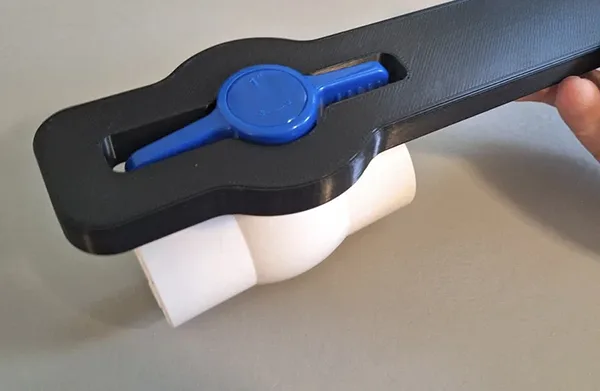 Making a PVC Valve Turn Easier A person using channel-lock pliers correctly on a PVC valve handle near its base