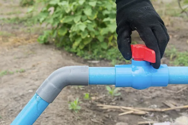 Purpose of PVC Ball Valve for Isolation A PVC ball valve installed in a pipe, isolating a water pump for maintenance